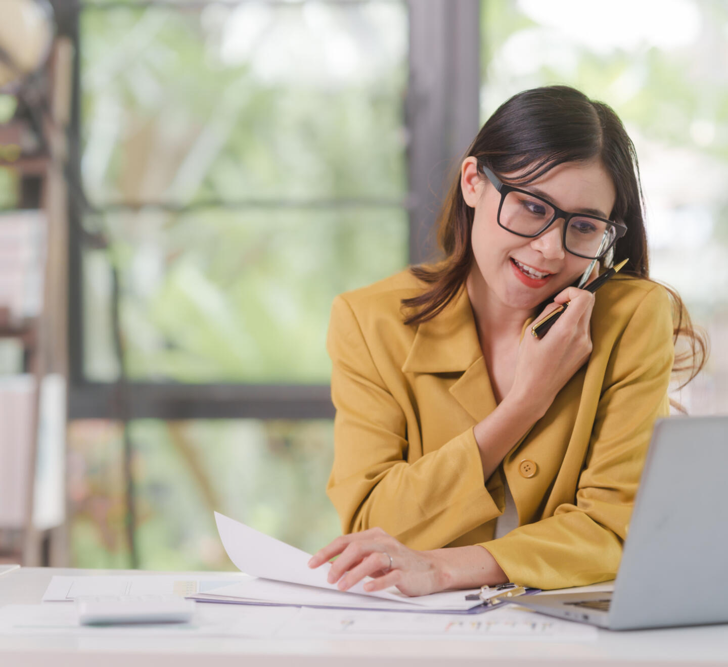 Professional woman with a laptop whilst on the phone