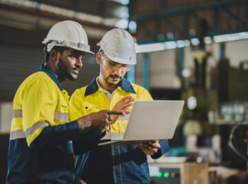 Two engineers looking at laptop
