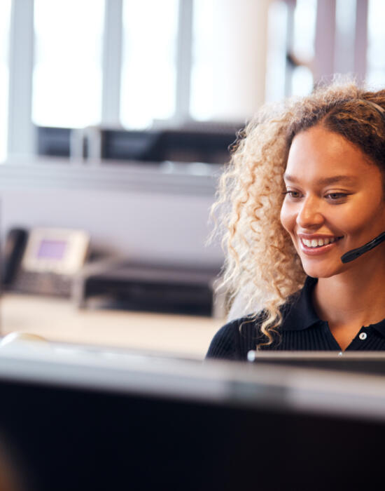 Smiling call centre agent with headset