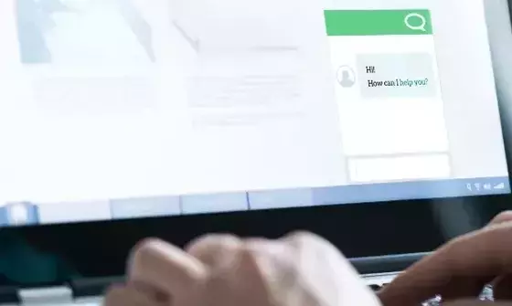 Person using web messaging on laptop