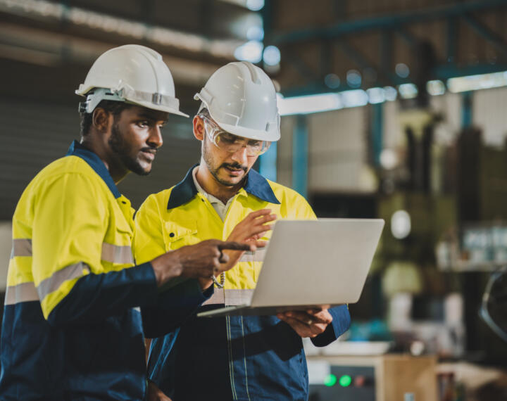 Two engineers looking at laptop